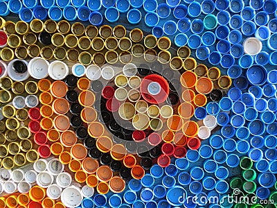 Background of plastic colorful bottle caps. Contamination with plastic waste. Environment and ecological balance. Art from junk. Stock Photo