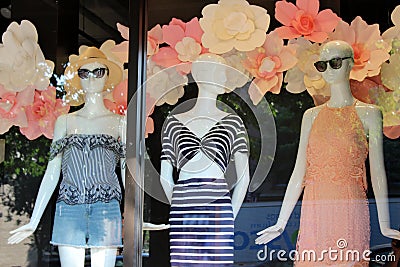 Three female mannequins dressed in springtime fashion and set in storefront windows, Saratoga, New York, 2018 Editorial Stock Photo