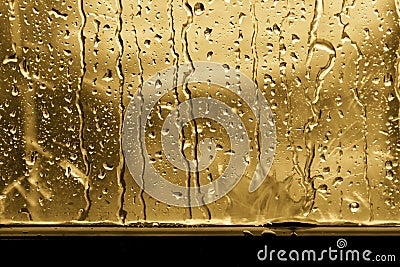 Background raindrop on window glass gold or yellow Stock Photo