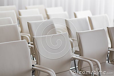Background of row of white seats. Empty chairs in the conference hall Stock Photo