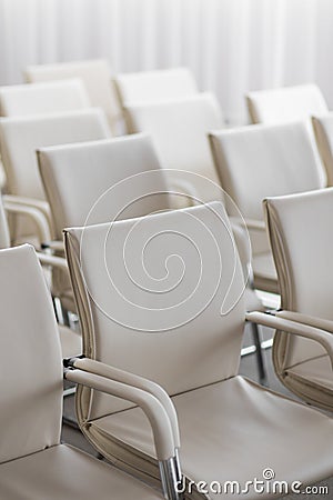 Background of row of white seats. Empty hairs in the conference hall Stock Photo