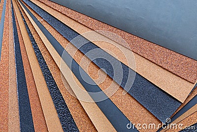 The background of the sandpaper surface, where the grains of sand on the sandpaper can be seen, and the difference in colors on Stock Photo