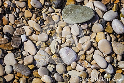 Background of Sea pebbles on a beach in sunlit Stock Photo