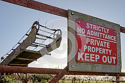 Improvised Keep-Out sign seen at the entrance no an old orchard and farm. Editorial Stock Photo