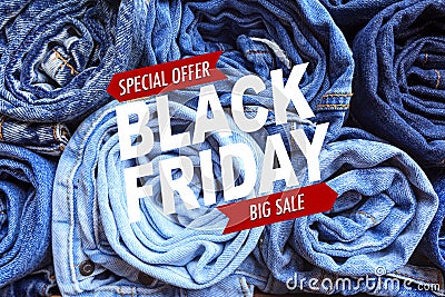 Background of a stack rolled jeans. Black friday sale - Image Stock Photo