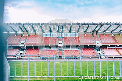 Background of the stadium tribune with green lawn seats Stock Photo