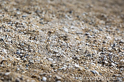 Background of stones on the shore. Close up in the blurry sunset light in the distance Stock Photo