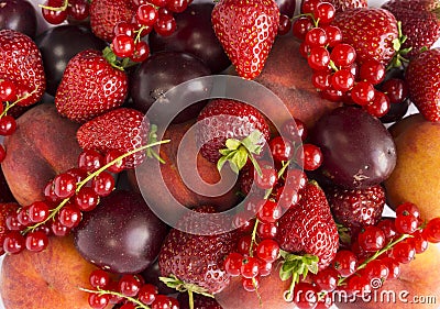 Background of strawberries, peaches, red currants and plums. Fresh berries closeup. Top view. Background of red berries. Various f Stock Photo