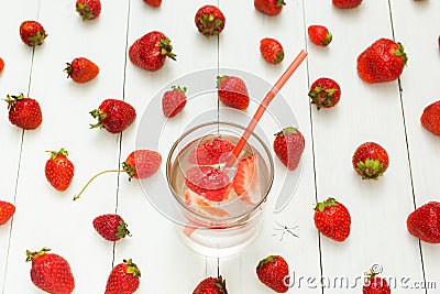 Background from strawberry water and fresh berries on a white table. Summer drink Stock Photo