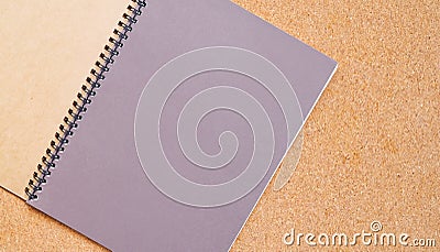 Notebook on a brown board with copy space for text Stock Photo