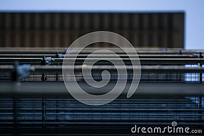 Background or texture in the blue sky of a crossbeam from building lattices. View of balconies from below. Cage, grid, wire. Stock Photo