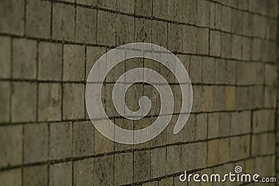 Background or texture from a broken and equal tile with patches of light and drops. Stone blocks on the sidewalk. Stock Photo