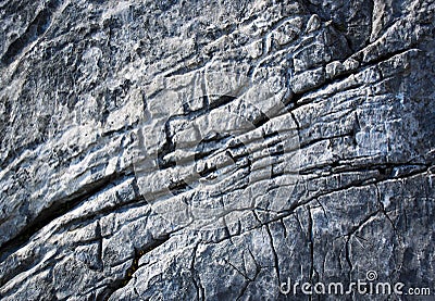 Detail of dark gray limestone rock with deep grooves Stock Photo