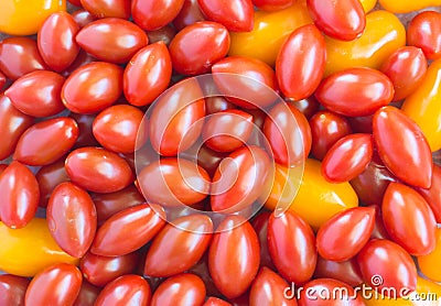 Background texture - jumble of red and orange grape tomatoes Stock Photo