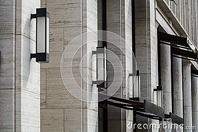 Background or texture from gray stone colomns and rectangular street wall lamps from metal and glass. Stock Photo