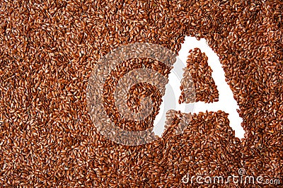 Vitamin A written in flax seed back ground. healthy diet. background with texture made of of brown flax seeds Stock Photo