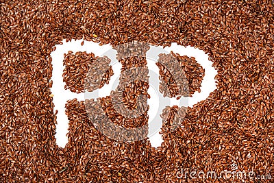 Background texture made of of brown flax seeds with a white letters P Stock Photo