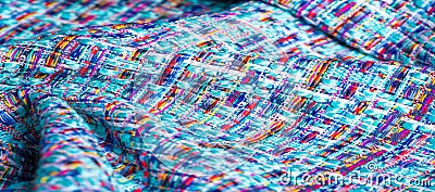 Background texture, pattern. Winter fabric, warm. big braided thread. Blue-red yellow threads. This photo will make your design Stock Photo