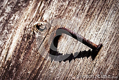 Rusty bent nail on the board Stock Photo