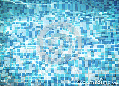 Background texture of water with mosaic bottom caustics ripple in swimming pool. Shining sun reflection, motion of wave. Stock Photo
