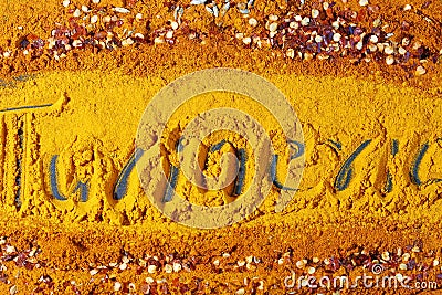 A background of turmeric powder with Turmeric text Stock Photo
