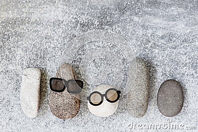Background with various funny characters of stones on the grey t Stock Photo
