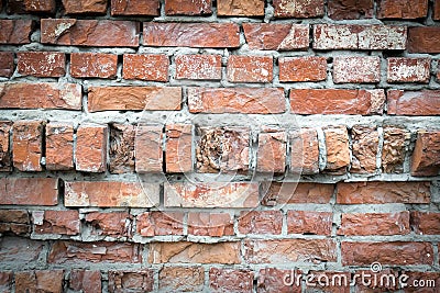 Background wallpaper of red orange cracked weathered old wrecked uneven rough brick wall, pattern, grunge surface Stock Photo