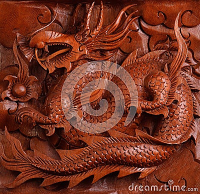 Background wood carving of a dragon Stock Photo