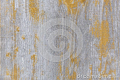 Background of a wooden gray surface with the remains of yellow paint.Close up Stock Photo