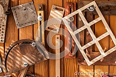 A background with wooden and metal tools hanging on the wooden wall. Stock Photo