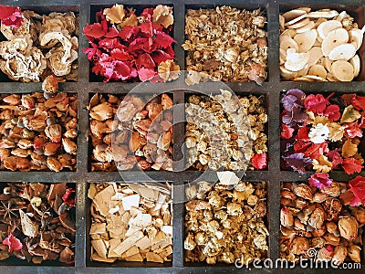 Background of wooden organizer container with variety of dried flowers and spices. Wooden box with multicolored flowers. Wellness Stock Photo