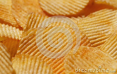 Background with yellow potato chips riffle. Close-up view. Natural product Stock Photo