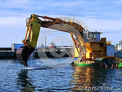 Backhoe Dredger Working In Harbour. Stock Photo