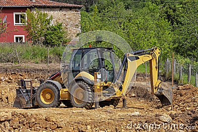 Backhoe excavating earth in a construction site Stock Photo