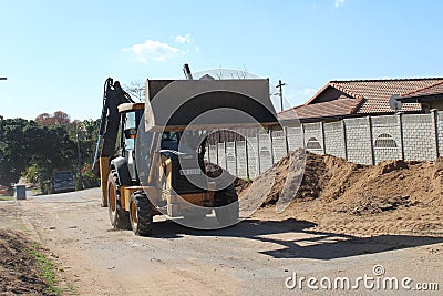 Backhoe loader moving soil in Durban Editorial Stock Photo