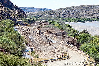 Backhoe loaders clearing sand that blocked canal at Boegoeberg Dam Editorial Stock Photo