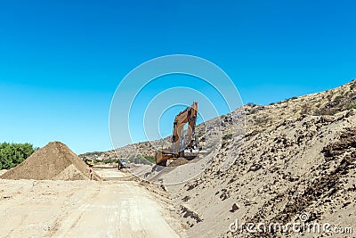 Backhoe loaders clearing sand from Boegoeberg Dam canal Editorial Stock Photo