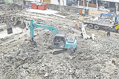 Backhoe penetrate the concrete construction. Stock Photo