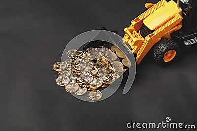 Backhoe tractor rake up money coins Stock Photo