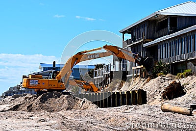 Backhoe working at fixing beach erosion. Editorial Stock Photo