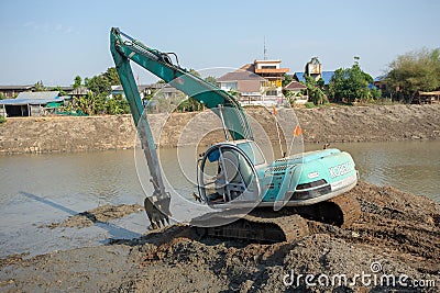 Backhoes digging sand with shovels .from the River Editorial Stock Photo