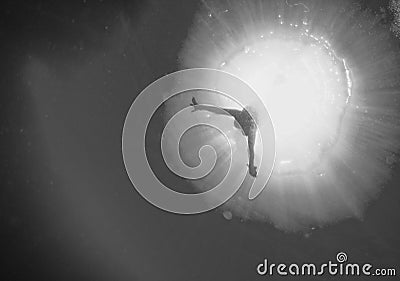 Backlight diver underwater in black and white Stock Photo