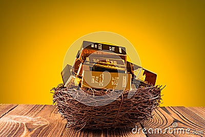 Backlit gold bars on nest concept of looking after your investment Stock Photo