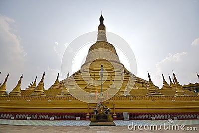 Backlit of main giant stupa of Shwemawdaw Pagoda surrounded with smaller stupas Stock Photo