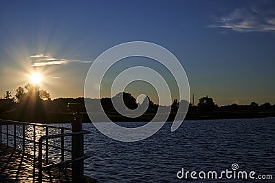 Backlit shot of a sunset at the coast of the Baltic Sea in Germany Stock Photo