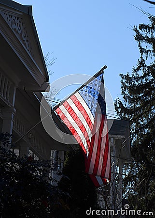 A backlit US Flag on an office building Stock Photo