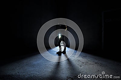 Backlit woman in concrete room Stock Photo