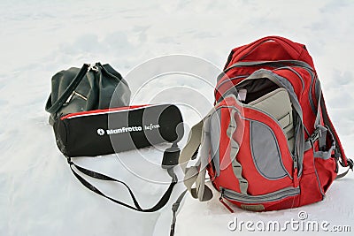 Backpack, bag, tripod in the snow. Preparing for video and photo shooting in the forest. Editorial Stock Photo