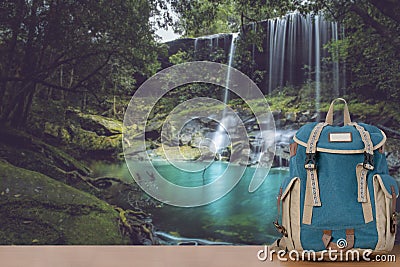 Backpack and beautiful waterfall landscape background Stock Photo