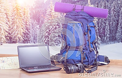 Backpack laptop and camera in winter background Stock Photo